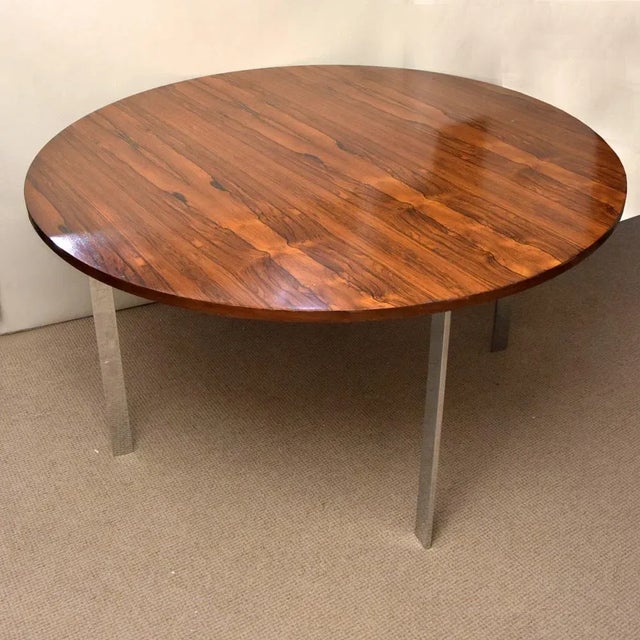 This round dining table with a rosewood top features chrome legs designed by Richard Young for Merrow Associates. This...