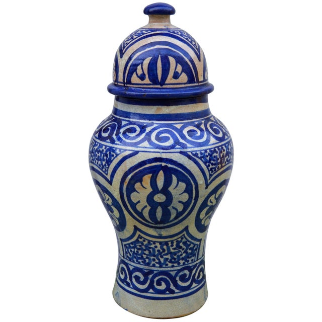 Handcrafted and glazed ceramic urn with lid from Fez, Morocco. Exhibits an intricate hand-painted blue Moorish pattern. No...