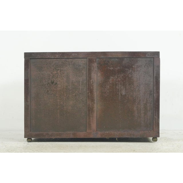 Reclaimed European rectangular vault box made of brown painted steel and cast iron with an orange painted interior. The...