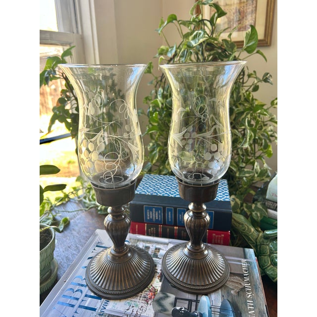 Perfect for an entry table or console, this pair of solid brass candlestick holders sport an antique bronze finish. They...