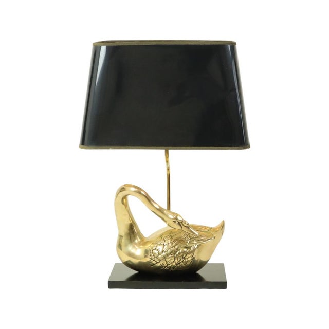 Large Hollywood Regency-style table lamp shaped like an elegant swan, featuring a black resin base and a black synthetic...