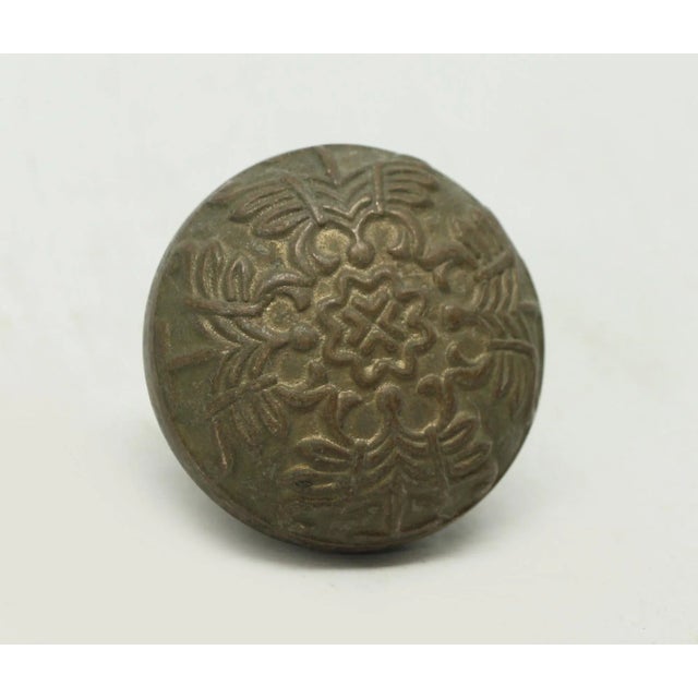 Antique collector's quality bronze passage door knob with a four fold design. Manufacturer and date of creation is...