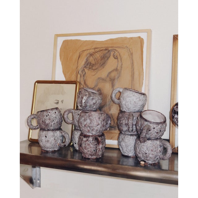 A 12 piece Italian ceramic mug and pitcher set by C.A.S. Vietri, produced in Vietri sul Mare during the 1970s. The set...