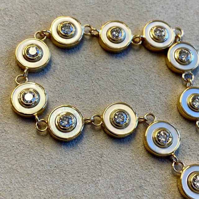 Created in 18 karat yellow gold Cosmic bracelet length 8 inches 18kyg lobster lock with sizing rings Mother of pearl 8...