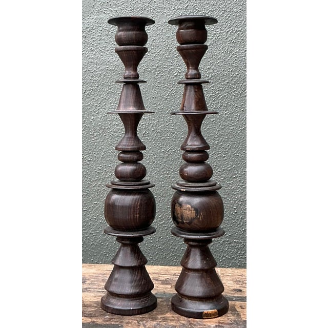 Elevate your mantel or dining centerpiece with this striking pair of vintage turned wood candlesticks. Crafted with an...