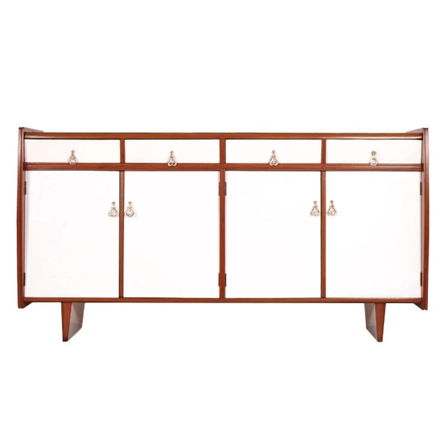 This Art Deco credenza in the style of Franco Albini was produced between the 1930s and 1940s. It is made of lacquered...