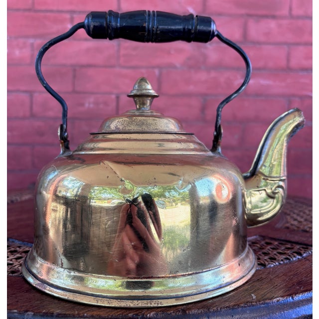 This is a gorgeous vintage solid-brass tea kettle featuring a polished rounded body, decorative curved spout, removable...