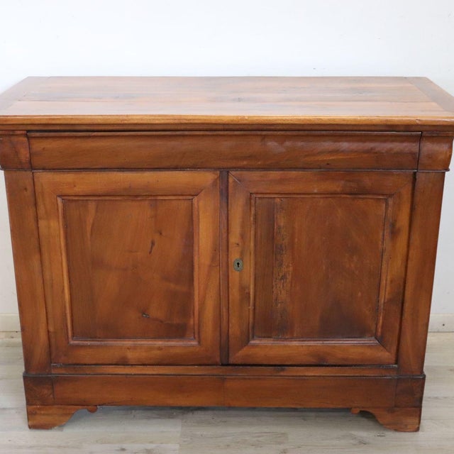 Antique Italian sideboard, crafted from solid walnut and dating back to the mid-19th century. This sideboard features...