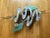 Unique memphis style wall art made with metal and has the metallic finishes on each of the following shapes: the two curvy...