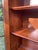 Sturdy wooden display cabinet with a warm cherry finish. This piece has three glass-paneled doors and three lower drawers...