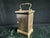 Tiffany & Co. brass carriage clock with beveled glass side panels and a top carry handle. White dial with black Roman...