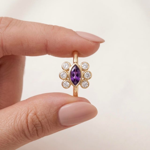 Elevate your jewelry collection with this captivating, vintage-inspired Marquise Amethyst Ring. This exquisite piece...