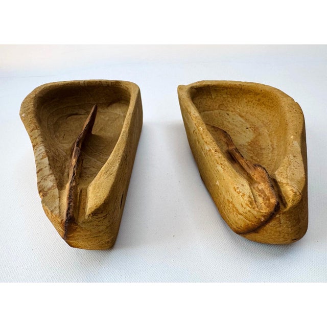Pair of hand carved stone vessels defined by a striking structural detail - a natural mineral vein left deliberately...