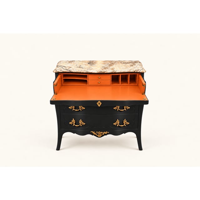 A dramatic Louis XV-style bombé commode presented in a sophisticated charcoal finish. Its curved silhouette is...