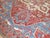 Fabulous early 20th century Persian Heriz carpet with a large ivory medallion on a tomato red field encased by four French...