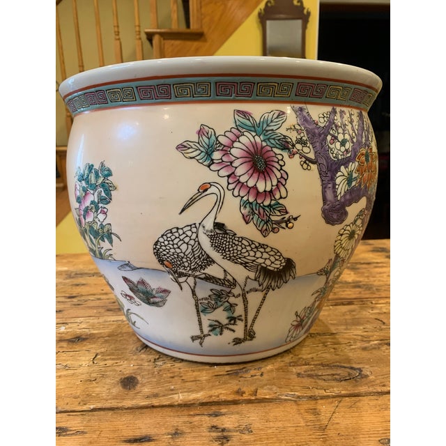 AI description: The product is a 10" mid-century Chinese export colorful hand-painted fish bowl planter cachepot. This...