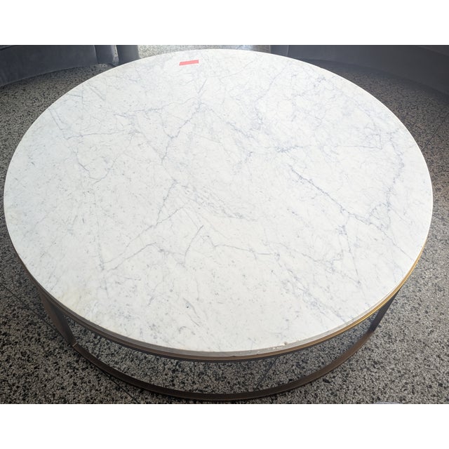Modern large marble coffee table from restoration hardware with a sleek gold metal undercarriage.
