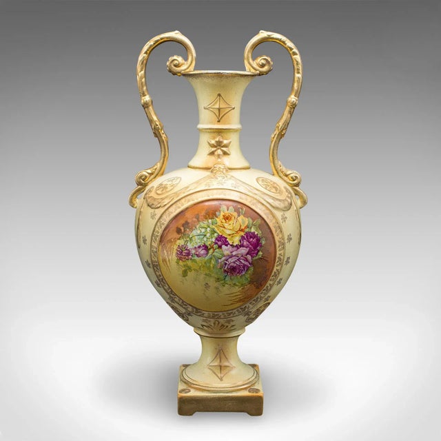 This is an antique flower vase. An English, ceramic baluster urn with Continental decor, dating to the early 20th century,...