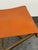 Design Plus Gallery presents the Directors Stool from CB2. This stool has an orange leather sling seat with stitched edge...