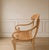 Bring timeless, artisanal character to your space with this striking vintage light-wood armchair. Perfectly balancing...