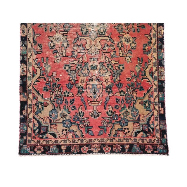 Vintage Turkish Sivas runner rug featuring an elegant floral medallion composition across a softly faded coral-red field....