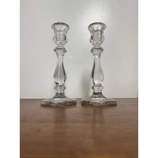 Pair of vintage clear glass candlestick holders, approximately 7.5” tall, with faceted hexagonal bases and decorative...
