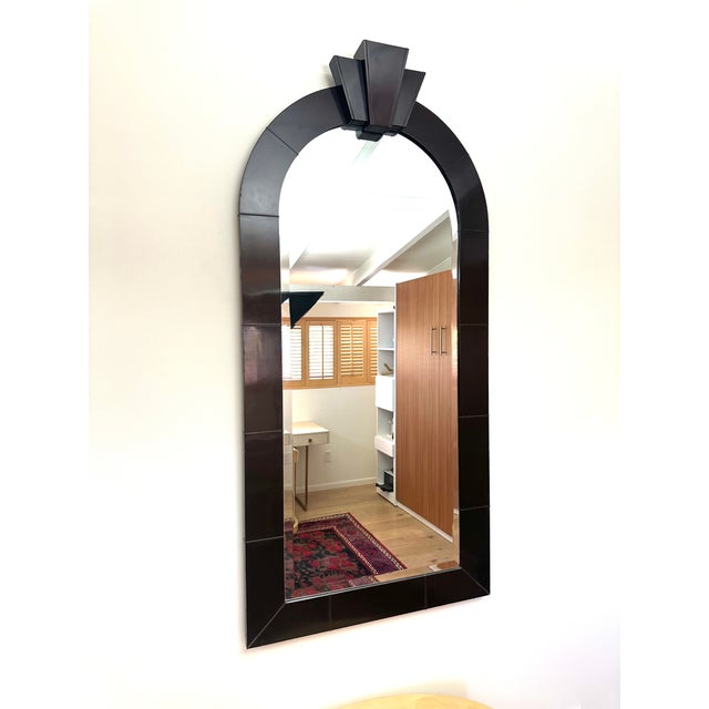 A large and important Karl Springer mirror with lacquered frame in bronze voilet color with beveled glass mirror and brass...