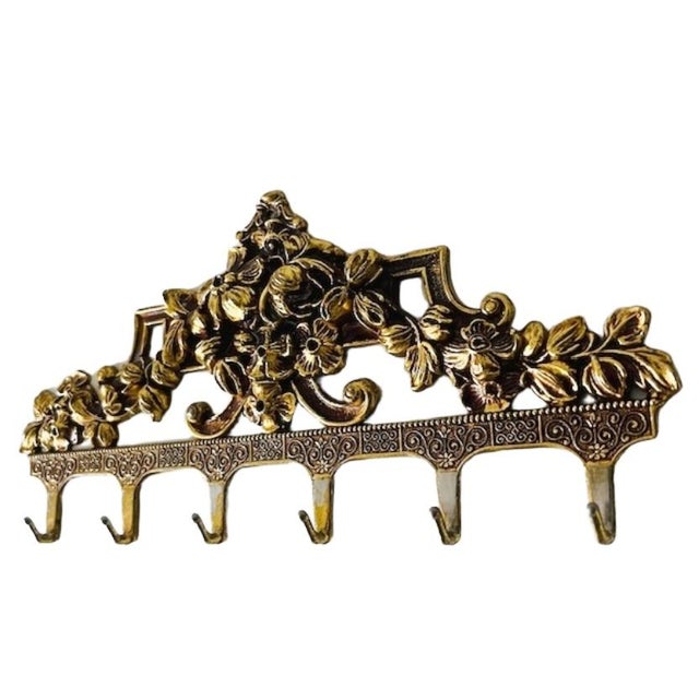 Beautiful vintage mid-century Italian coat rack in baroque style, made of brass in the 1960s. It also makes a lovely...