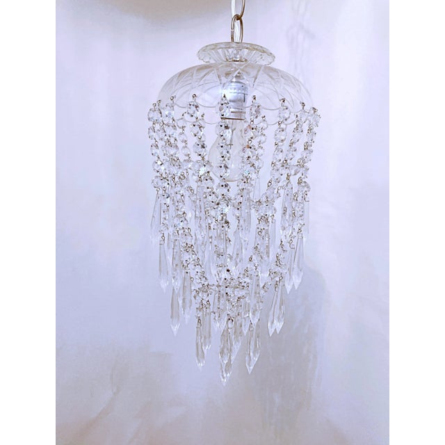 This a very unique style chandelier that is in a parachute form. IT has a hand cut glass dome and draped octagon chain and...