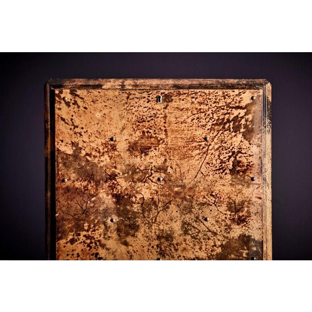 Mid-Century bar cabinet by Aldo Tura. Made from wood with laquered goatskin. Inside we find an illuminated mirrored...