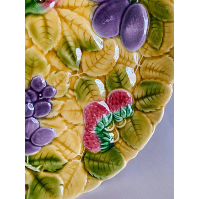 A lovely colorful serving plate with fruit and leaf motifs. (French Majolica/ Barbotine faience) from the famous...