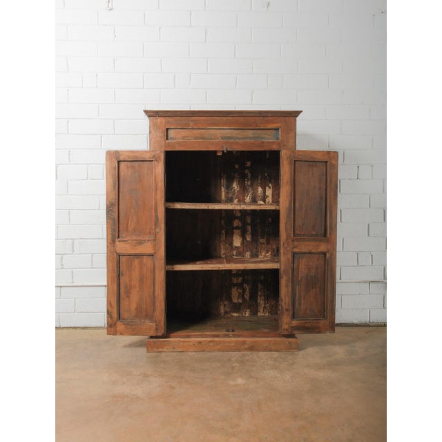 This Indian storage cabinet showcases the timeless beauty of traditional craftsmanship and naturally aged materials....