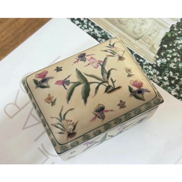Decorative porcelain box with lid by g&c denmark. rectangular form with colourful botanical decoration featuring flowers,...