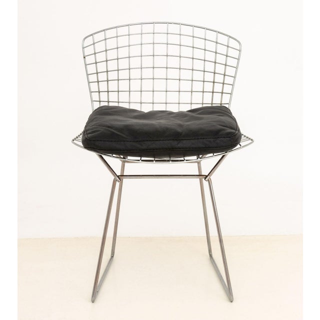 Harry Bertoia Black Enameled Steel Wire Chair, with black leather seat cushion. 30" H x 21" W x 19.75" D; seat: 20.5" H....