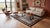 This striking hand-woven wool rug seamlessly marries traditional Navajo-inspired geometric motifs with a sophisticated...