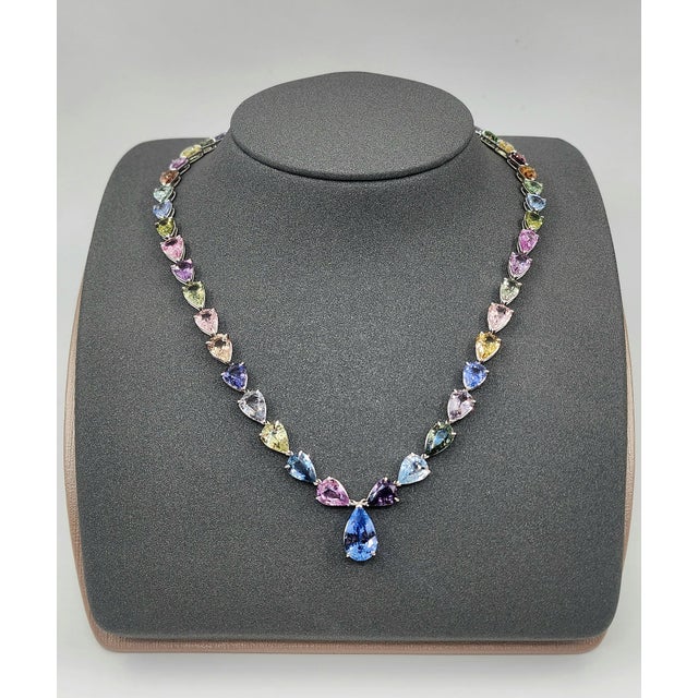 This mesmerizing rainbow sapphire necklace is a striking expression of color and modern elegance, beautifully crafted in...