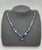 This mesmerizing rainbow sapphire necklace is a striking expression of color and modern elegance, beautifully crafted in...