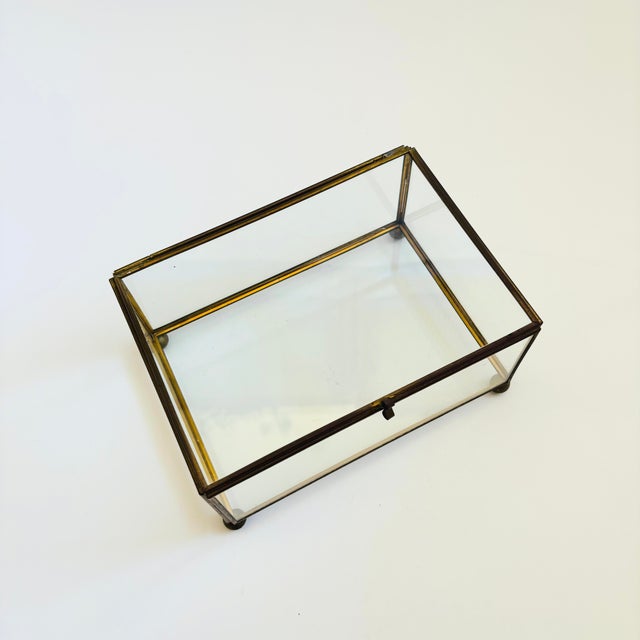 A lovely vintage brass and glass box. Thin panes of glass are held together by a welded brass frame. Perfect for keeping...