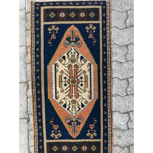 This is a vintage Turkish Oushak rug from the 1960s. The piece was hand-knotted.