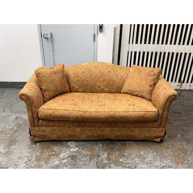 Design Plus Gallery presents a Bespoke Traditional Camelback Loveseat with floral patterned upholstery in muted gold, sage...