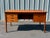 Danish teak desk with four drawers and bookcase on back side. Classic Danish Modern design elements including raised edge...