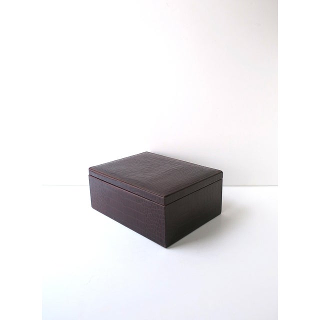 A dark brown faux‑crocodile embossed leather jewelry or accessory box, American Classical design style, in the manner of...
