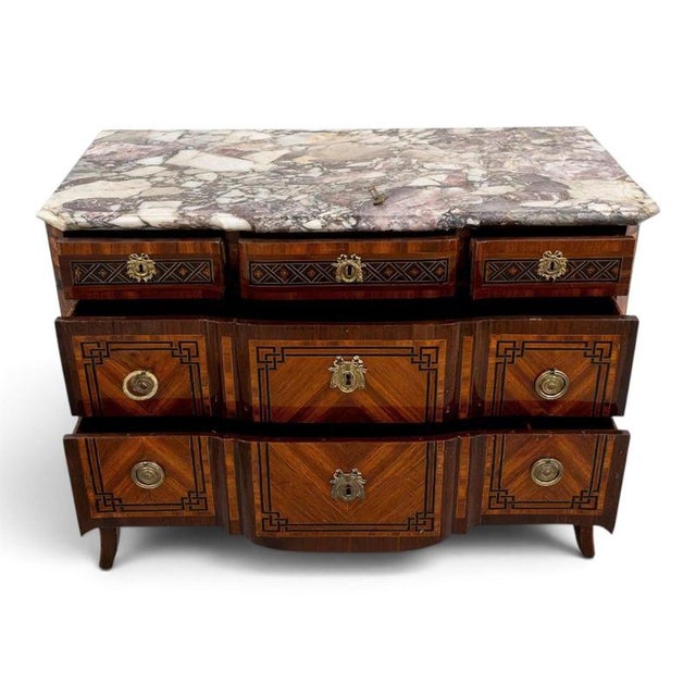 This elegant 18th-century french transition chest of drawers combines the graceful lines of the louis xv period with the...