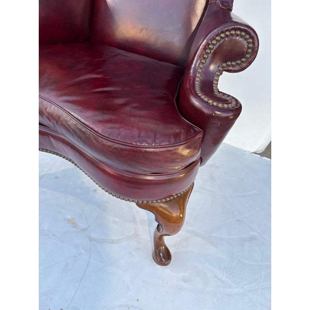 A wonderful Chippendale Style Wingback Chair made by Kittinger. Upholstered in a burgundy / oxblood fine leather. Great...