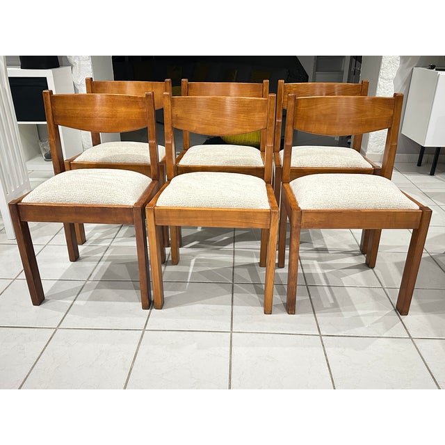 Set of six chairs attributed to Regain France, vintage 1980. Chairs made entirely of solid elm in an amber finish, with...