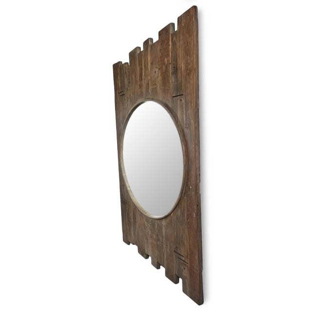 Salvaged wood fence post fragments repurposed as a unique rustic large mirror frame. Round mirror set inside the staggered...