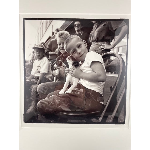 Up for sale a Nick Meek circa 2001 framed unsigned black and white photograph of a young boy with his puppy. A very sweet...
