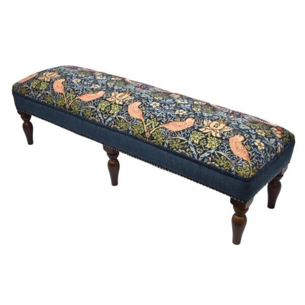 Meticulously handcrafted in the United Kingdom, this upholstered stool boasts classic studding and hand-polished solid...
