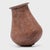 This petite hand-formed vessel bears a richly textured surface of worn red clay slip and dark smoke marks. Likely intended...