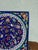 A magnificent hand-painted decorative ceramic wall tile on a deep cobalt blue ground, featuring an intricate central...